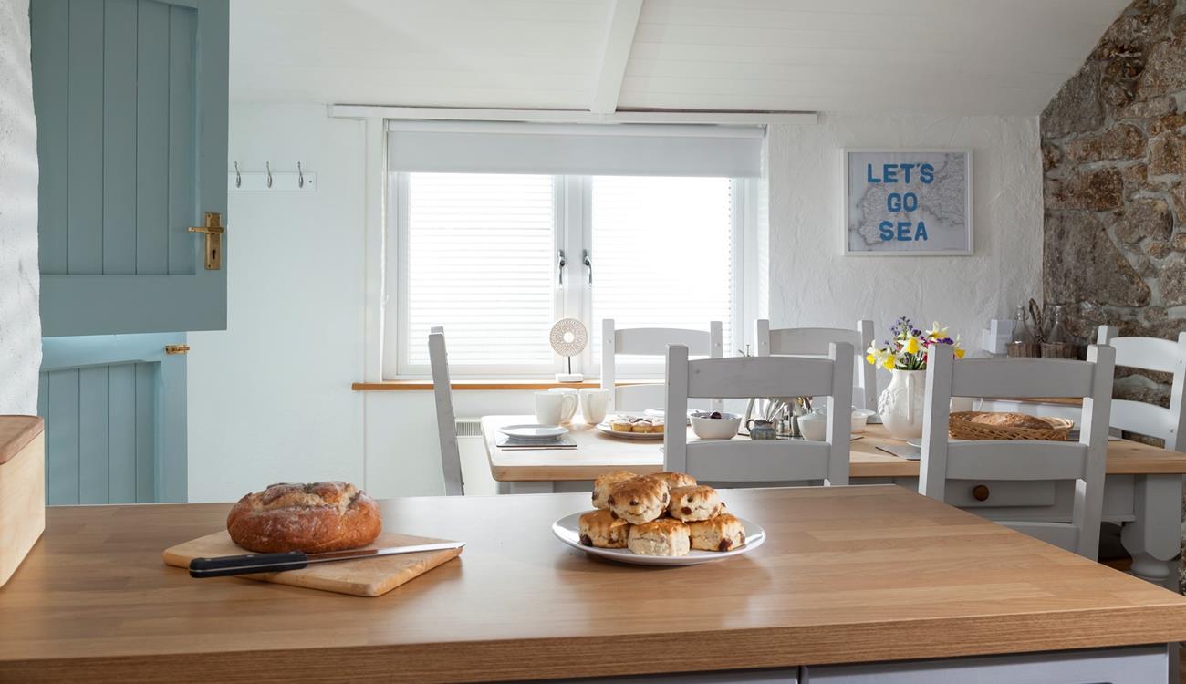 With its stable door, exposed granite wall, farmhouse-style table and slanted roof, the dining room exudes character and charm.