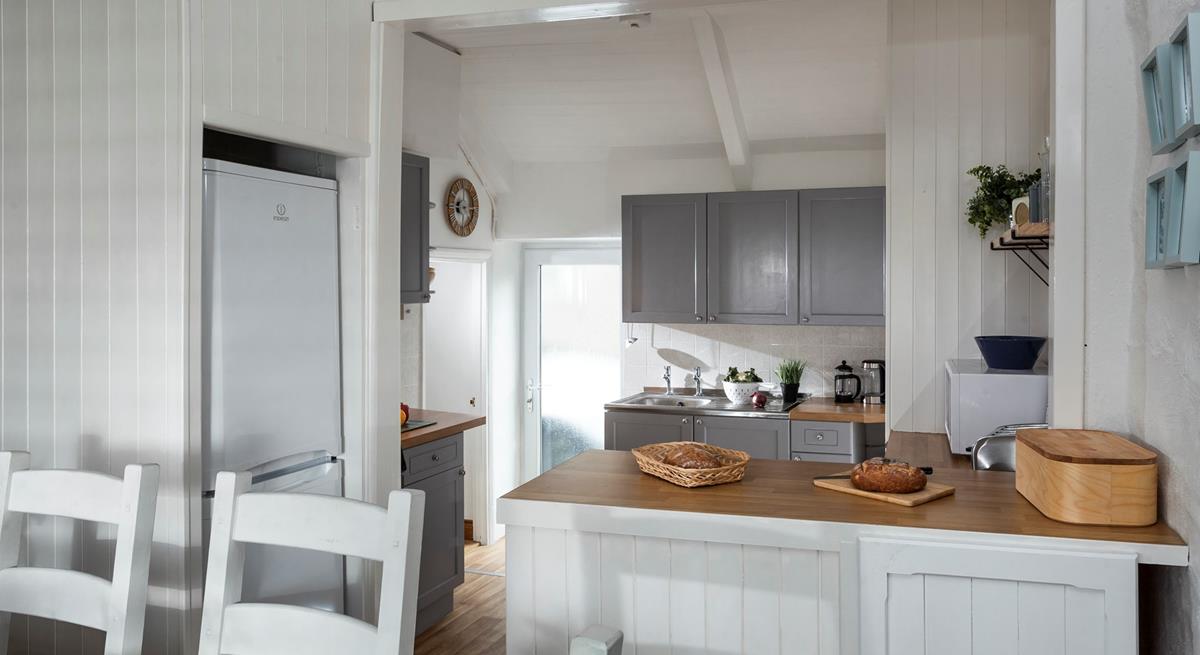 The open plan kitchen diner is well-designed for cooking whilst socialising. 