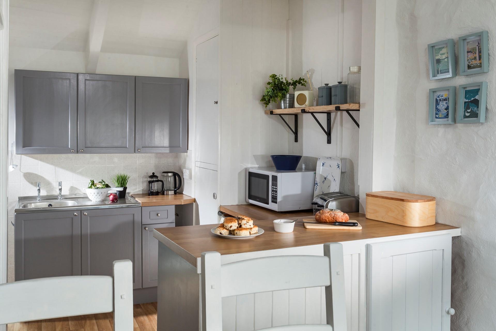 Quaint and welcoming, the kitchen is well-equipped with everything you need. 