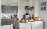 Quaint and welcoming, the kitchen is well-equipped with everything you need.  - Thumbnail Image