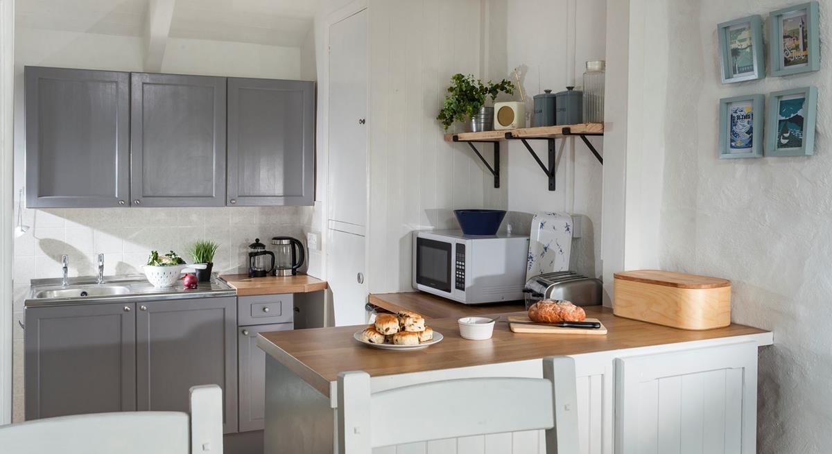 Quaint and welcoming, the kitchen is well-equipped with everything you need. 