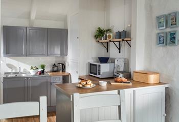 Quaint and welcoming, the kitchen is well-equipped with everything you need. 
