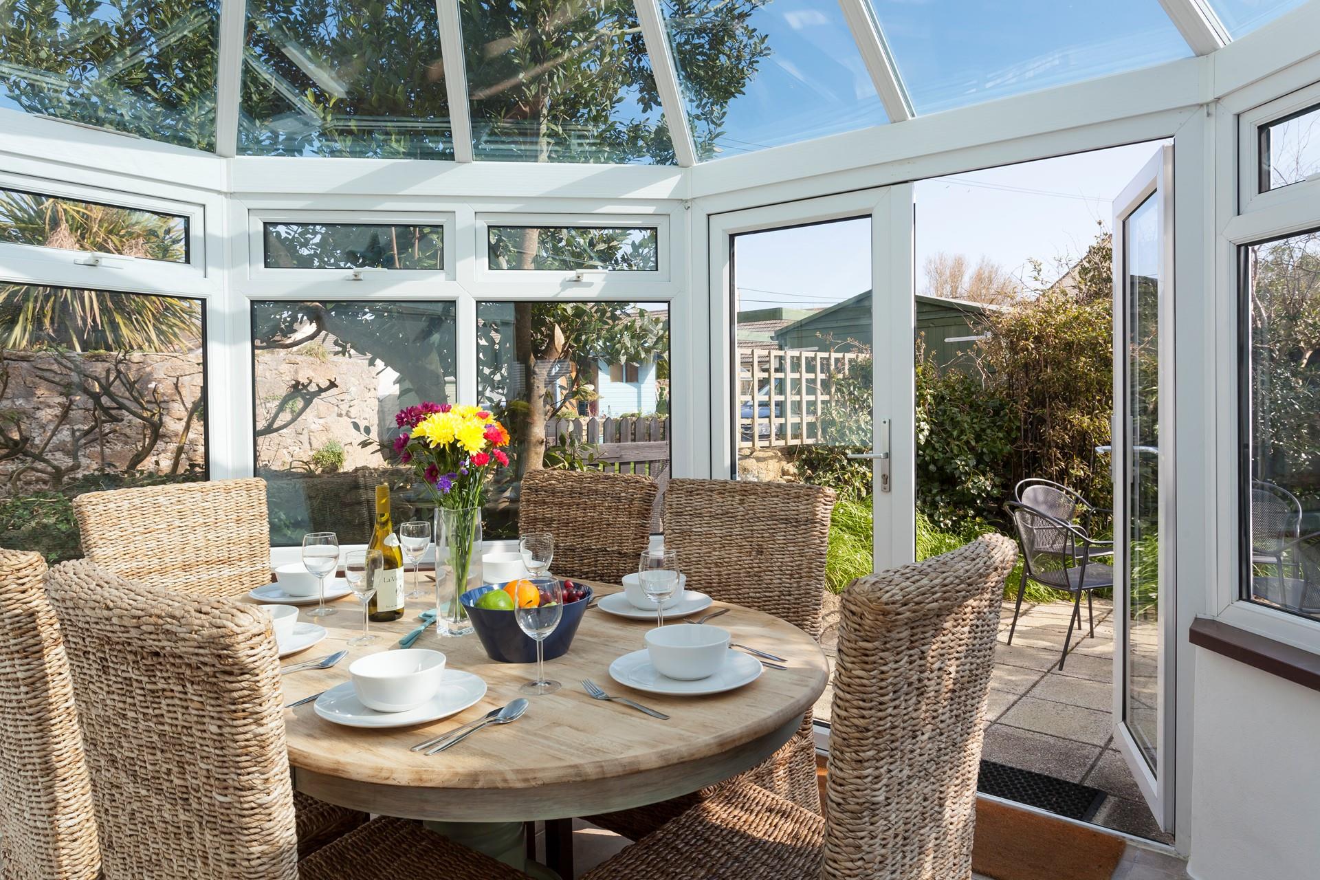 Gather together for a leisurely lunch or evening meal in the sunny conservatory. 