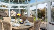 Gather together for a leisurely lunch or evening meal in the sunny conservatory. 