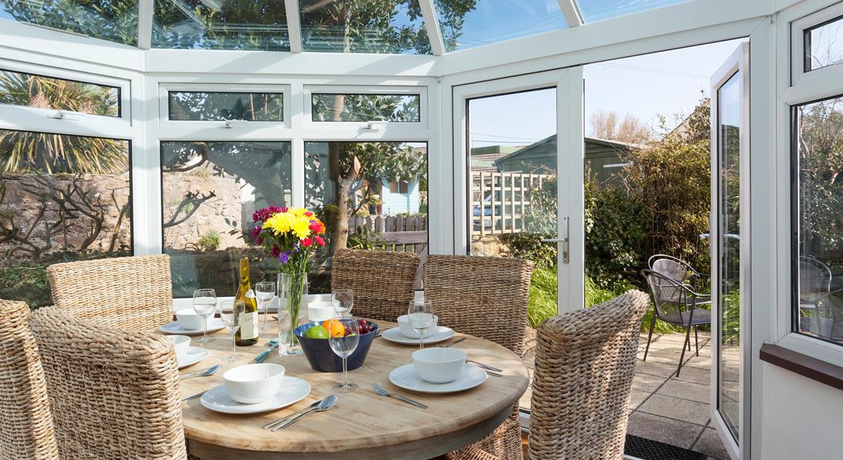Gather together for a leisurely lunch or evening meal in the sunny conservatory. 