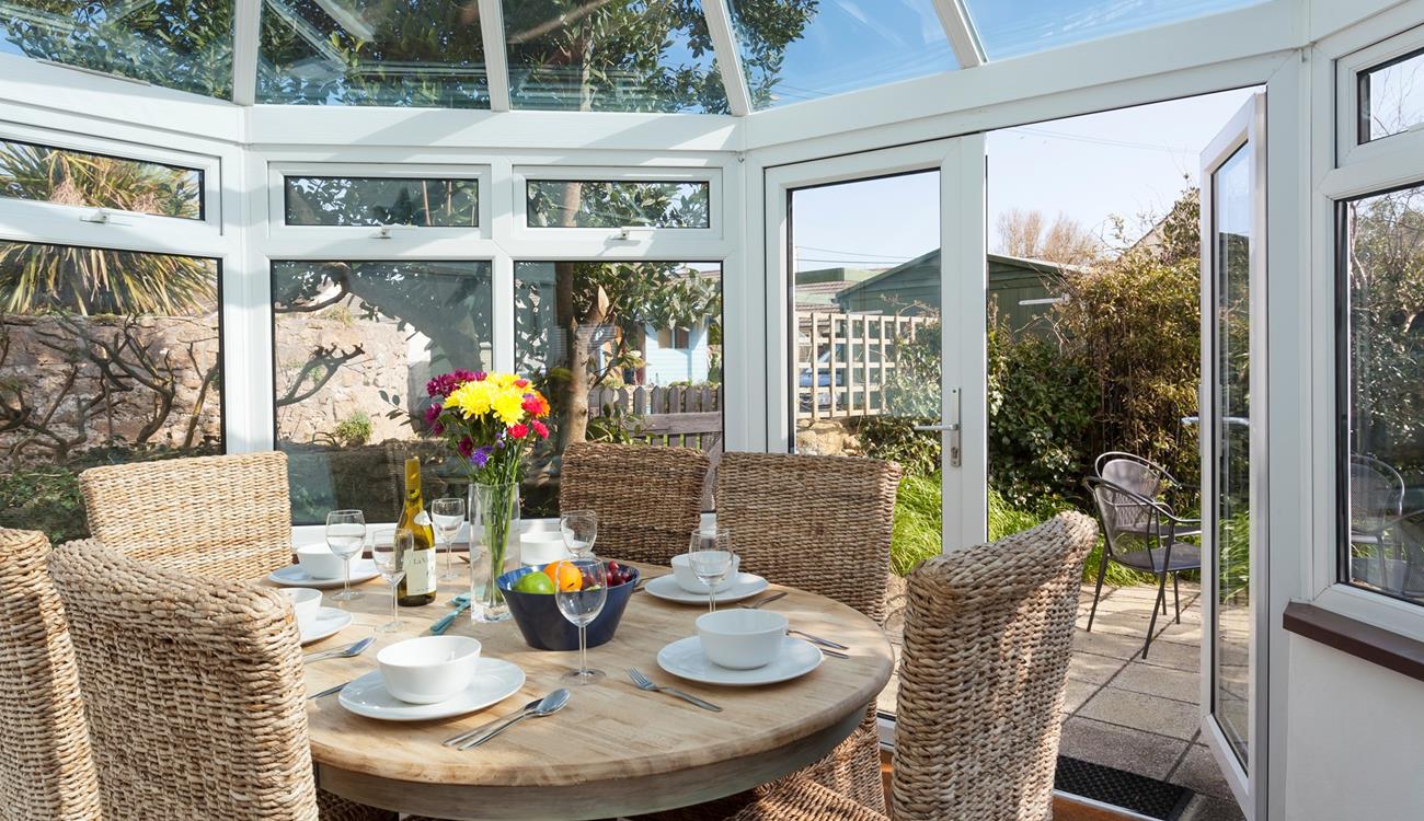 Gather together for a leisurely lunch or evening meal in the sunny conservatory. 