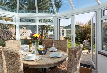 Gather together for a leisurely lunch or evening meal in the sunny conservatory. 