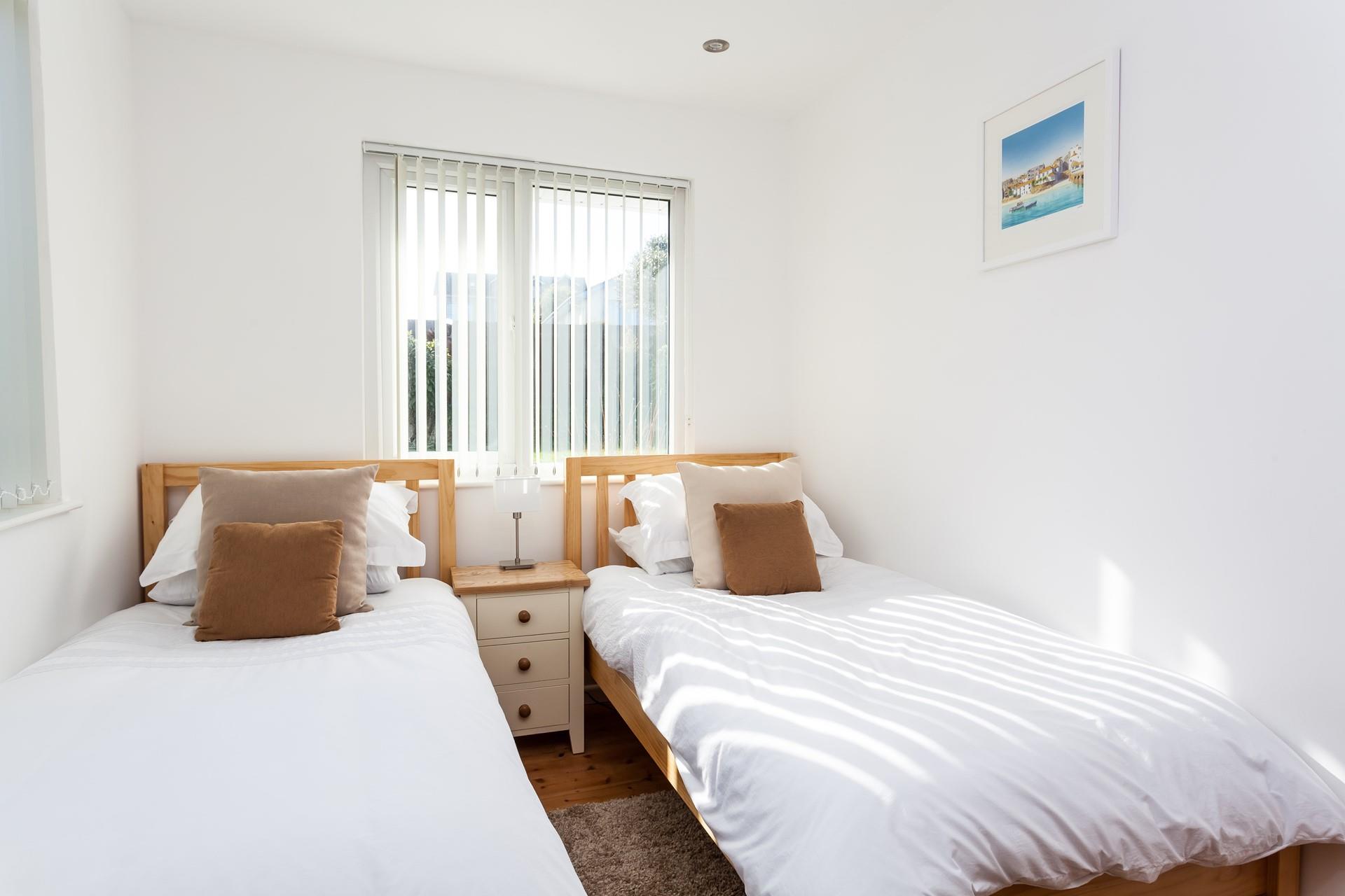 Modern and bright, the twin room is perfectly sized for two children, or adults sharing. 