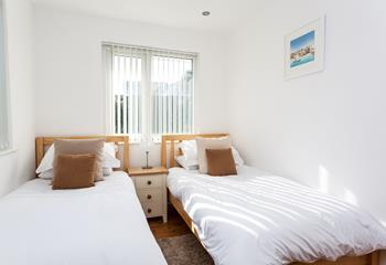 Modern and bright, the twin room is perfectly sized for two children, or adults sharing. 