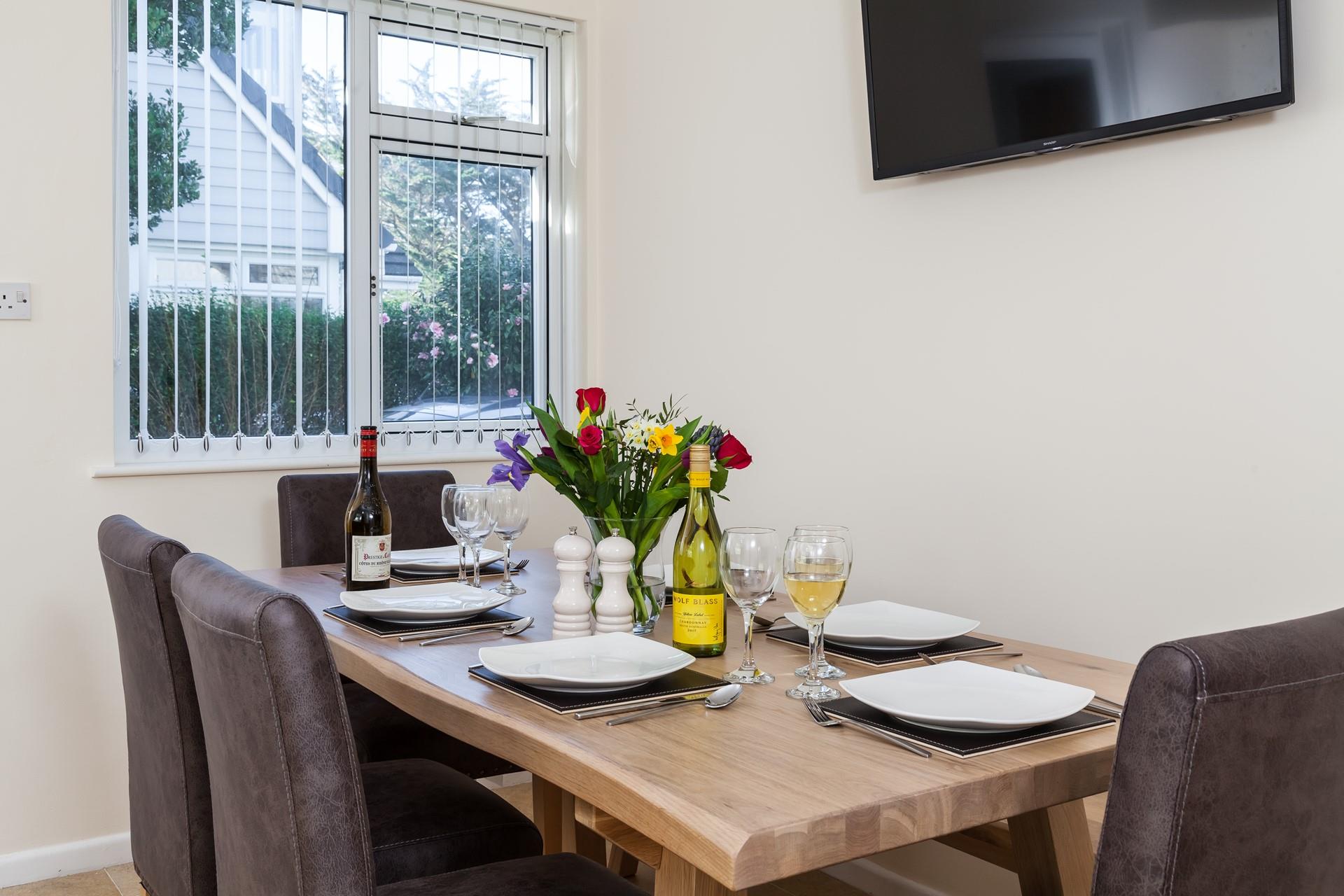 Pour a glass of wine and enjoy some Cornish food together at the stylish dining table. 