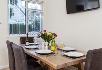 Pour a glass of wine and enjoy some Cornish food together at the stylish dining table. 