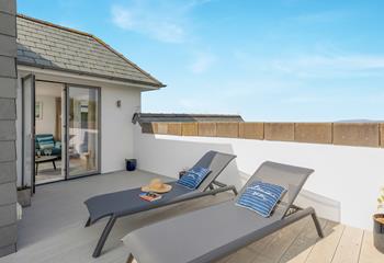 Relax together on the loungers after a busy day exploring the coast.