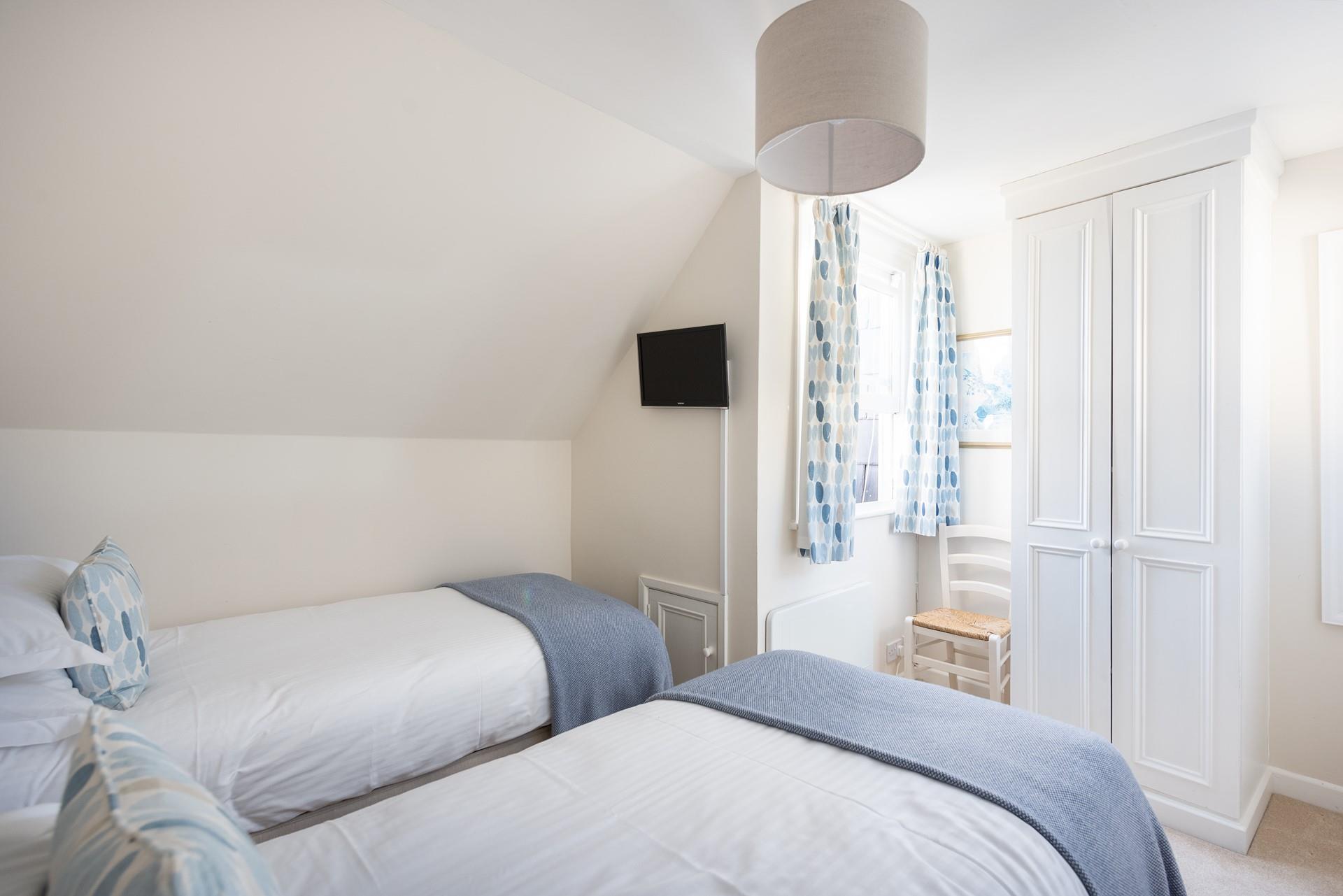 The twin room is well-proportioned for two children sharing. 