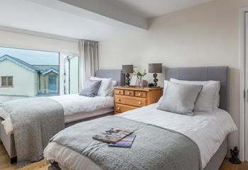 Bedroom 2 has super comfy twin beds and sumptuous cushions and throws.