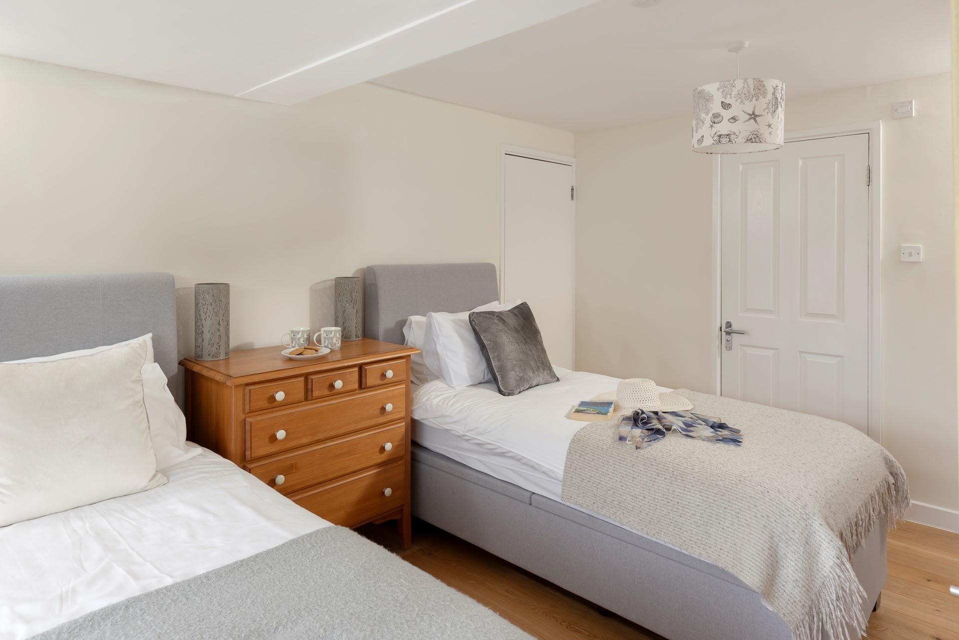 Bedroom 2 has super comfy twin beds and sumptuous cushions and throws.