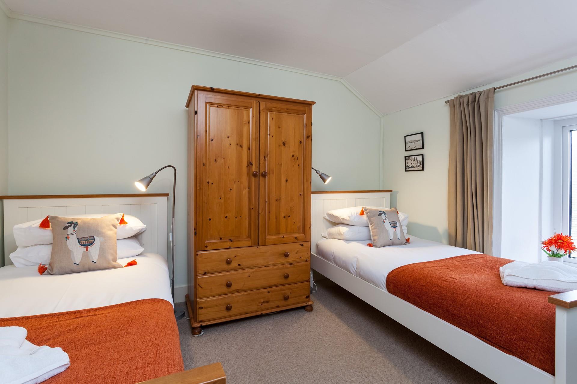 Twin beds with fun pops of colour are perfect for children.