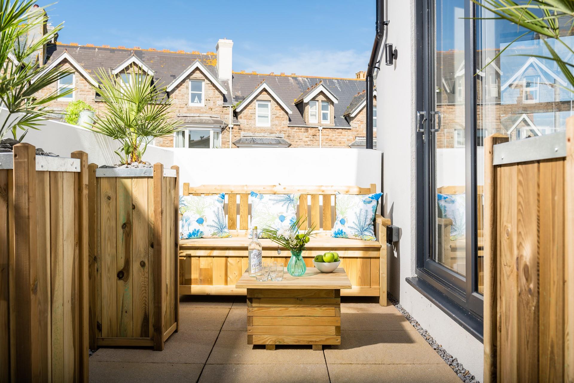 Unwind on the patio, a lovely sheltered area for sitting in the sun.