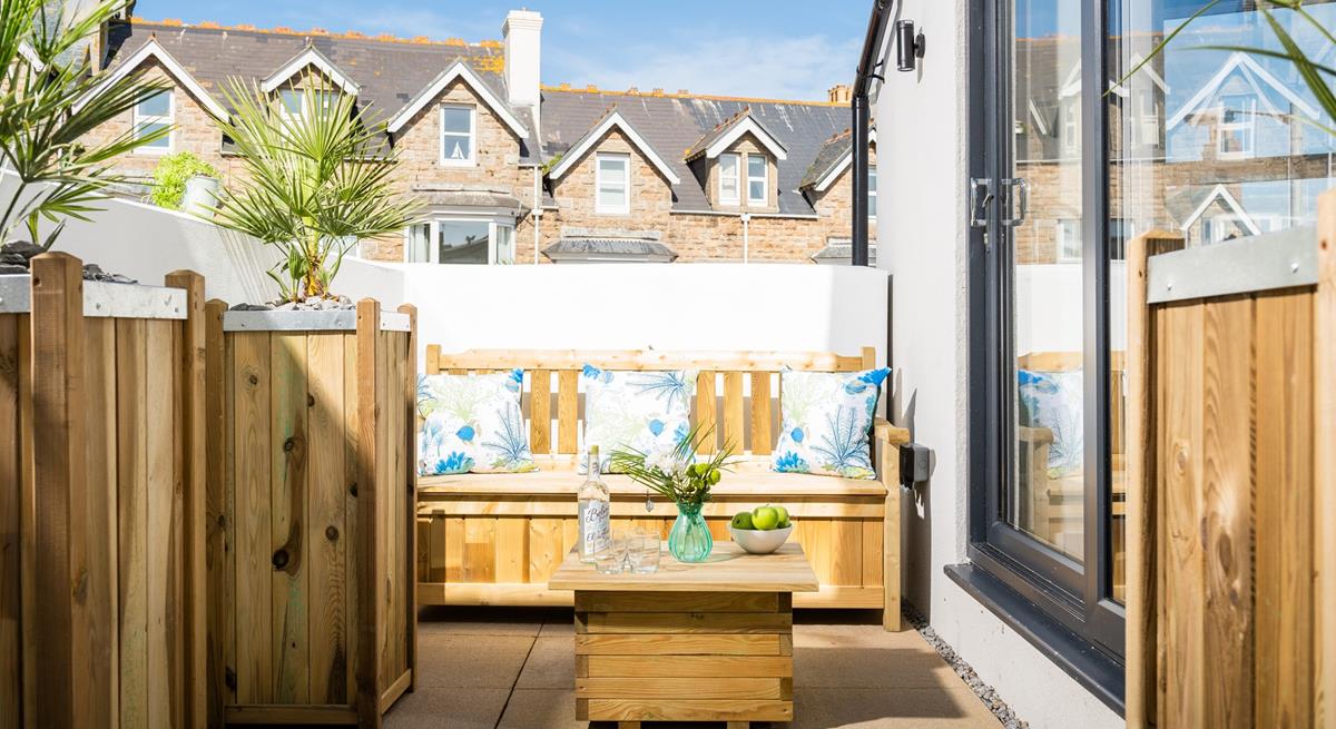 Unwind on the patio, a lovely sheltered area for sitting in the sun.