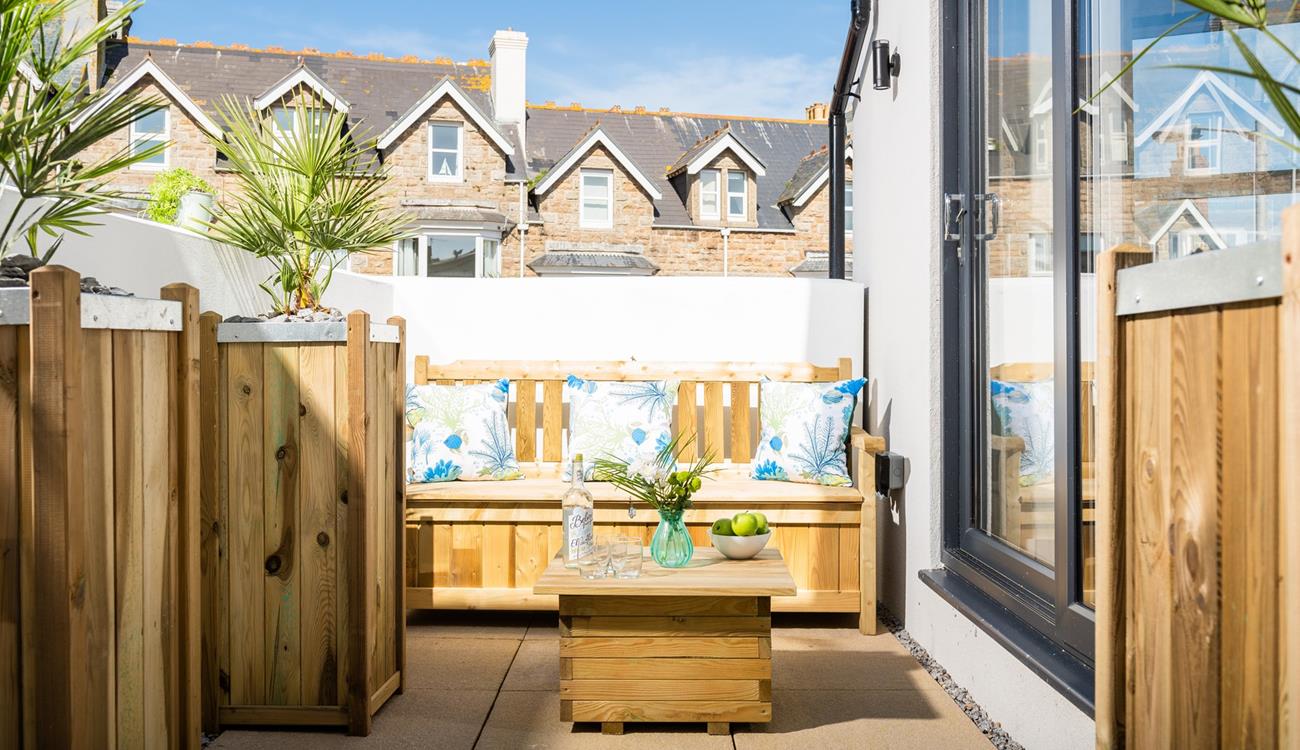 Unwind on the patio, a lovely sheltered area for sitting in the sun.