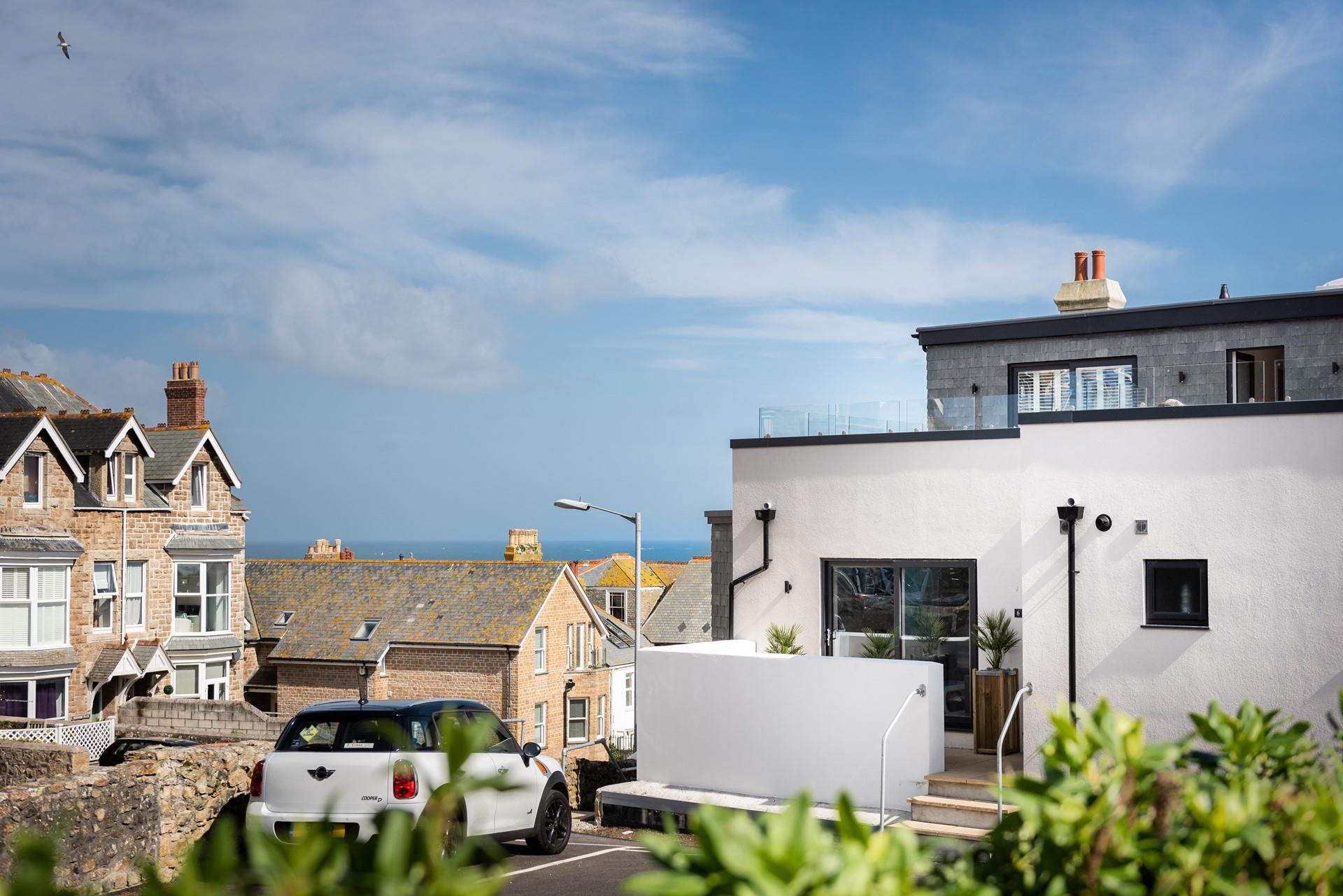Car parking for the apartment is just over the patio wall and across the rooftops, you can see the sea!