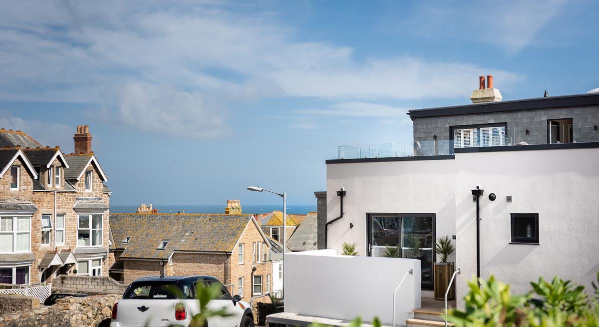 Car parking for the apartment is just over the patio wall and across the rooftops, you can see the sea!