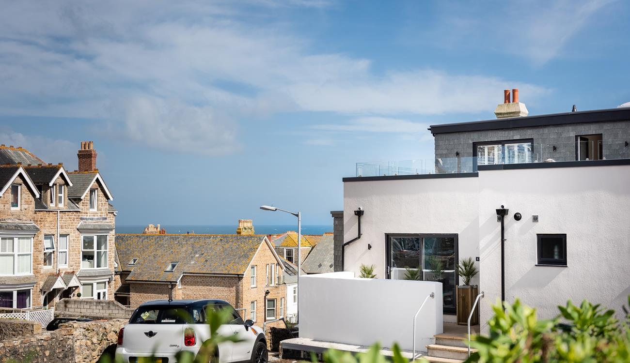 Car parking for the apartment is just over the patio wall and across the rooftops, you can see the sea!