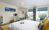 Bedroom 1 is spacious with pops of colour, the perfect place to rest each night. - Thumbnail Image