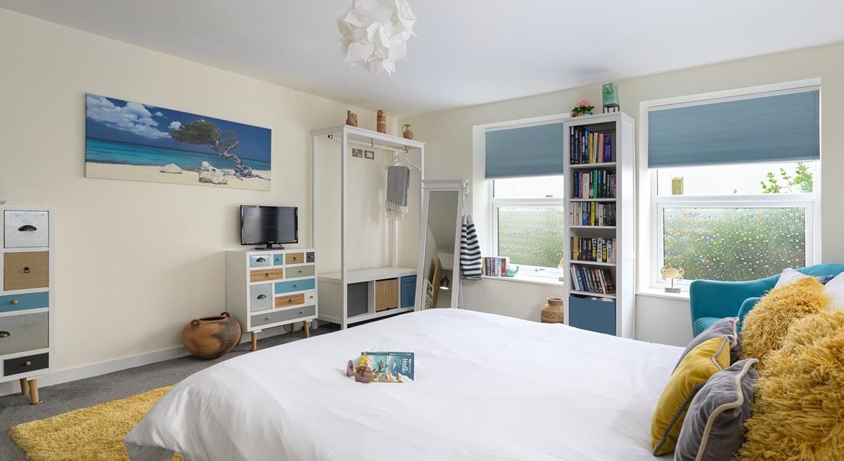 Bedroom 1 is spacious with pops of colour, the perfect place to rest each night.