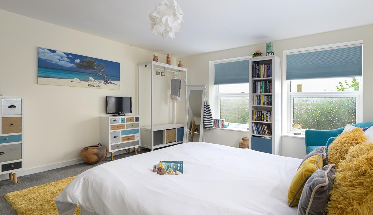 Bedroom 1 is spacious with pops of colour, the perfect place to rest each night.