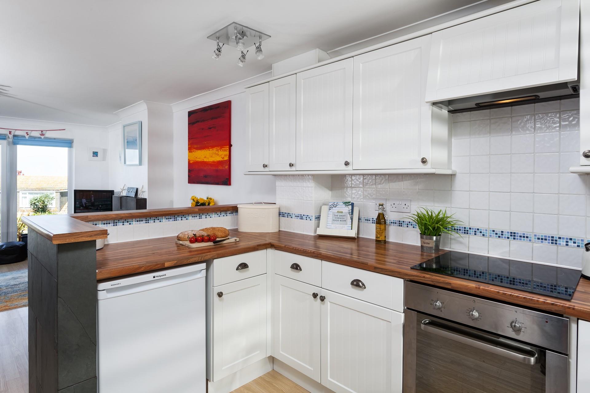 The open plan living area creates a lovely social space and harnesses the natural light gained from the floor to ceiling windows. 