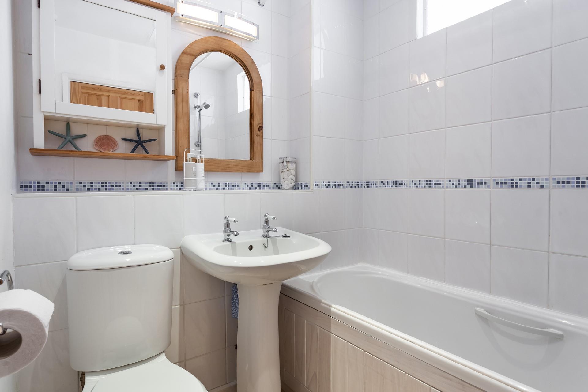 The bathroom has a lovely, homely feel, perfect for a relaxing soak.