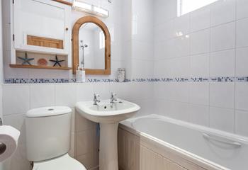 The bathroom has a lovely, homely feel, perfect for a relaxing soak.