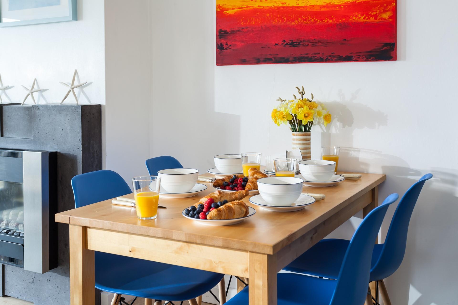 The bright colours work perfectly in this contemporary holiday home, with modern artwork.