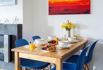 The bright colours work perfectly in this contemporary holiday home, with modern artwork.