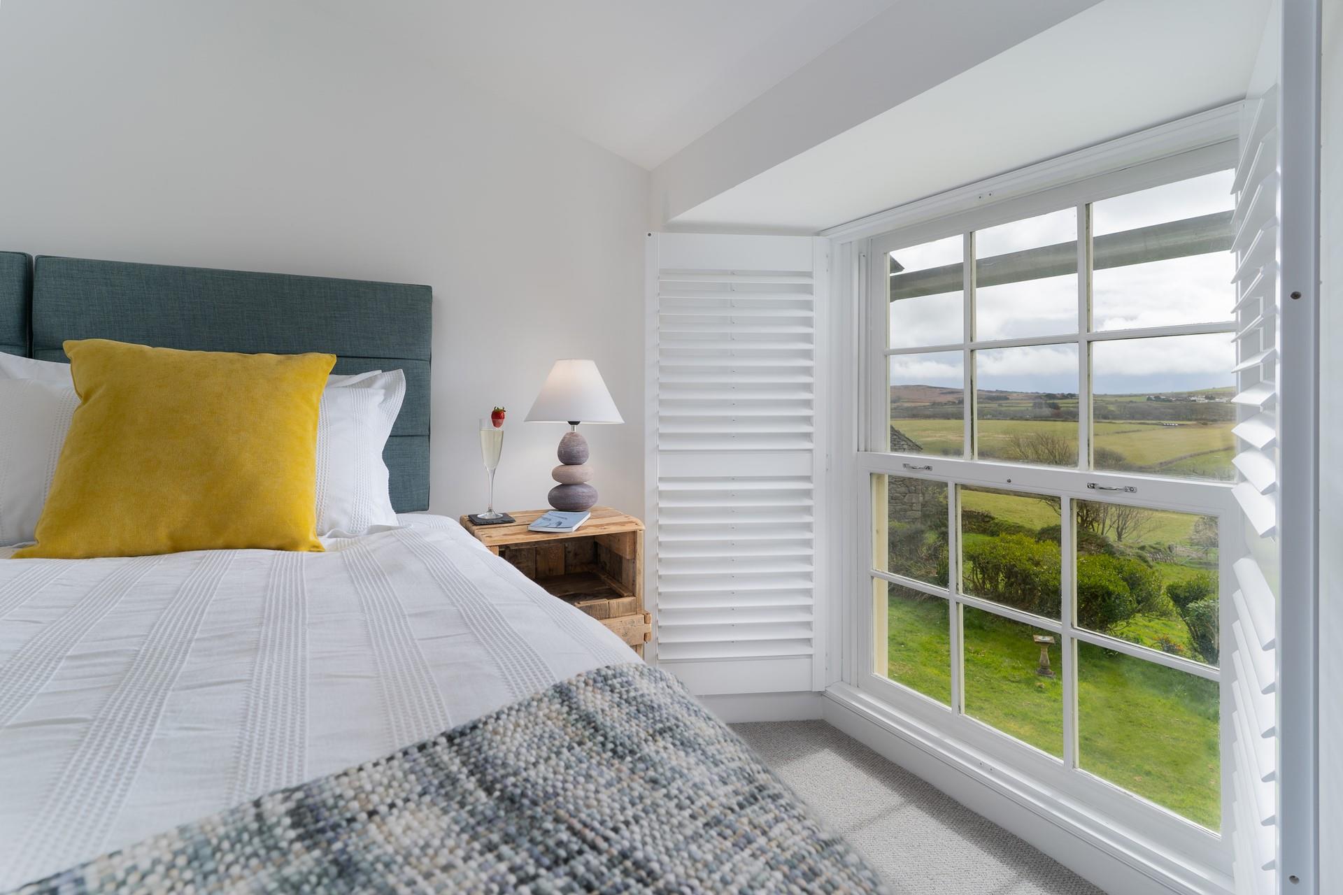 French-style shutters open up to reveal beautiful rural views. 