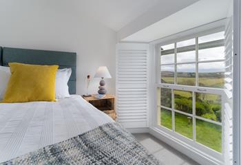 French-style shutters open up to reveal beautiful rural views. 