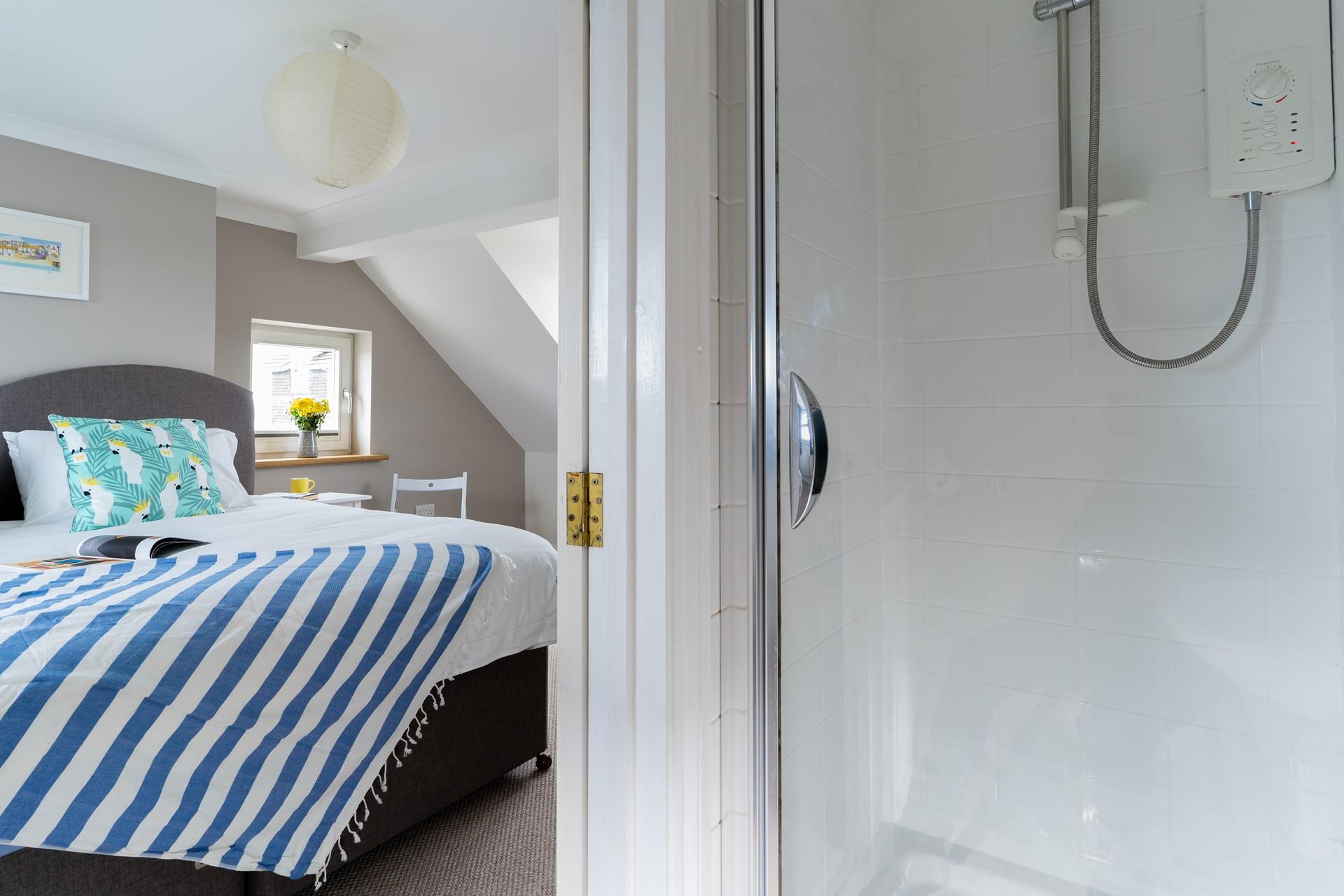 Bedroom 3 has an en suite with an enclosed electric shower, perfect for an after beach refreshing shower.
