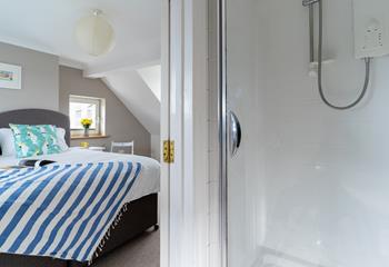 Bedroom 3 has an en suite with an enclosed electric shower, perfect for an after beach refreshing shower.