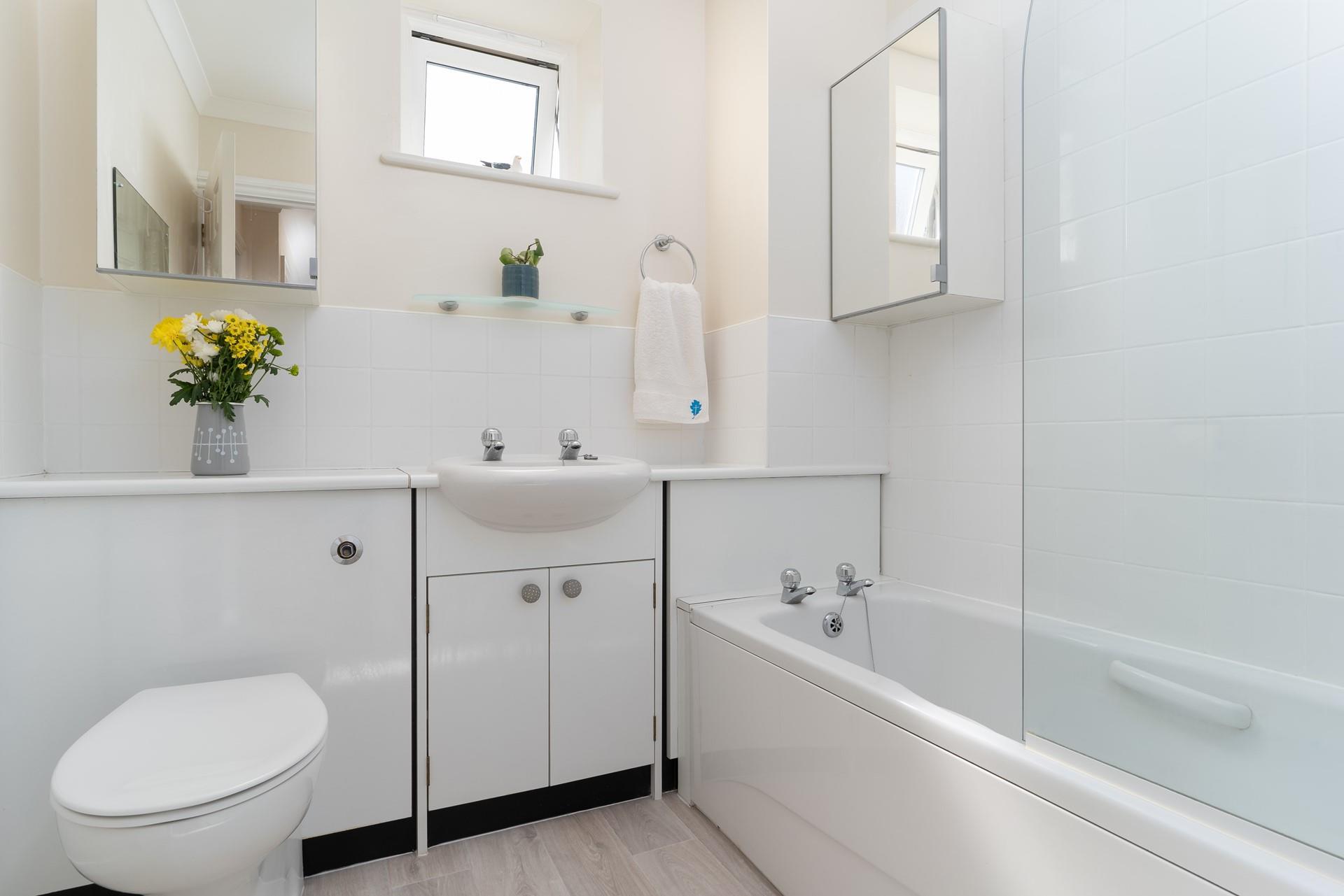 Choose between a relaxing bath or an invigorating shower in the family bathroom.