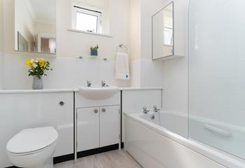 Choose between a relaxing bath or an invigorating shower in the family bathroom.