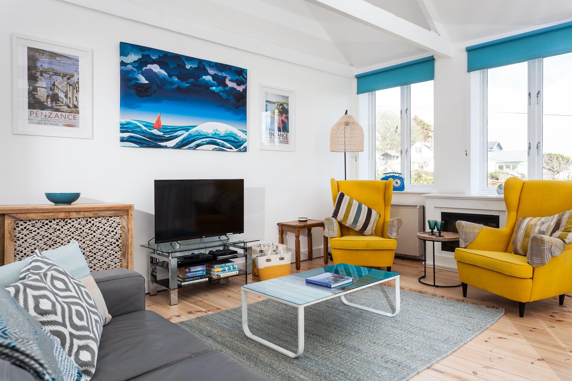 The cool, coastal sitting room provides a space to relax after busy beach days.