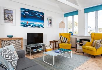 The cool, coastal sitting room provides a space to relax after busy beach days.