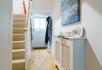 The hallway mixes practical furnishings with quirky, coastal decor.