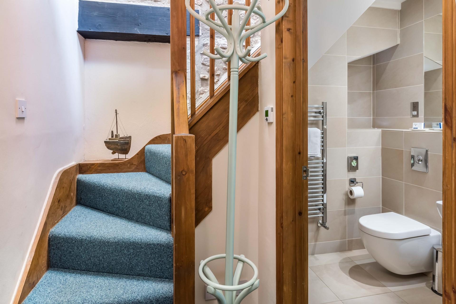 Stairs to the first floor mezzanine level bedroom.