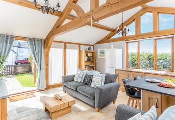 The open plan living space is full of character and charm with its exposed beams and stylish furnishings.