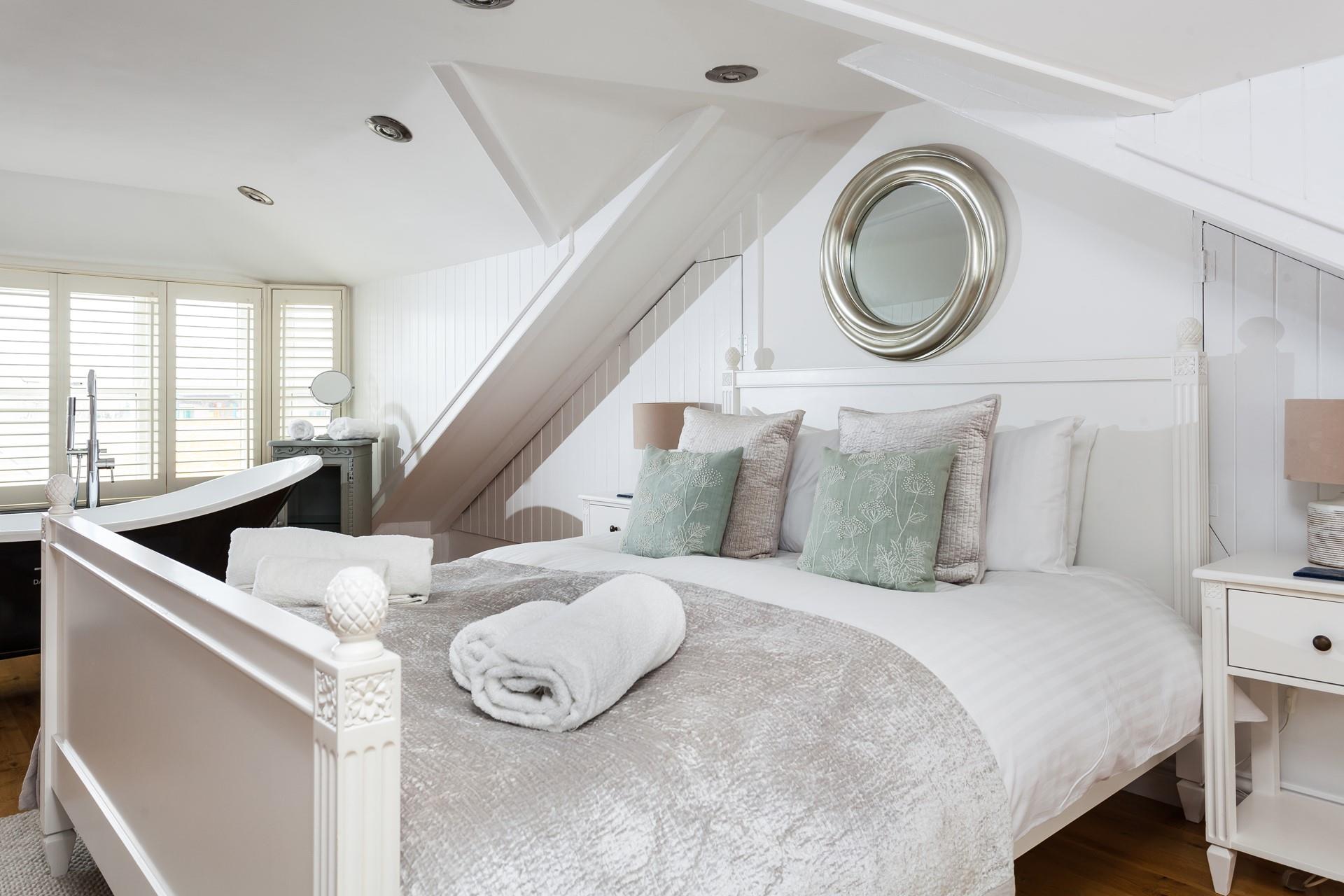 Soft sheets and fluffy towels await you after a relaxing soak in the bath.