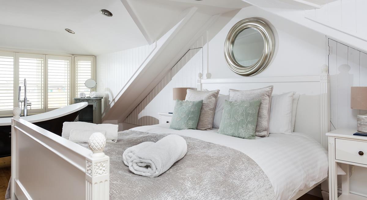 Soft sheets and fluffy towels await you after a relaxing soak in the bath.