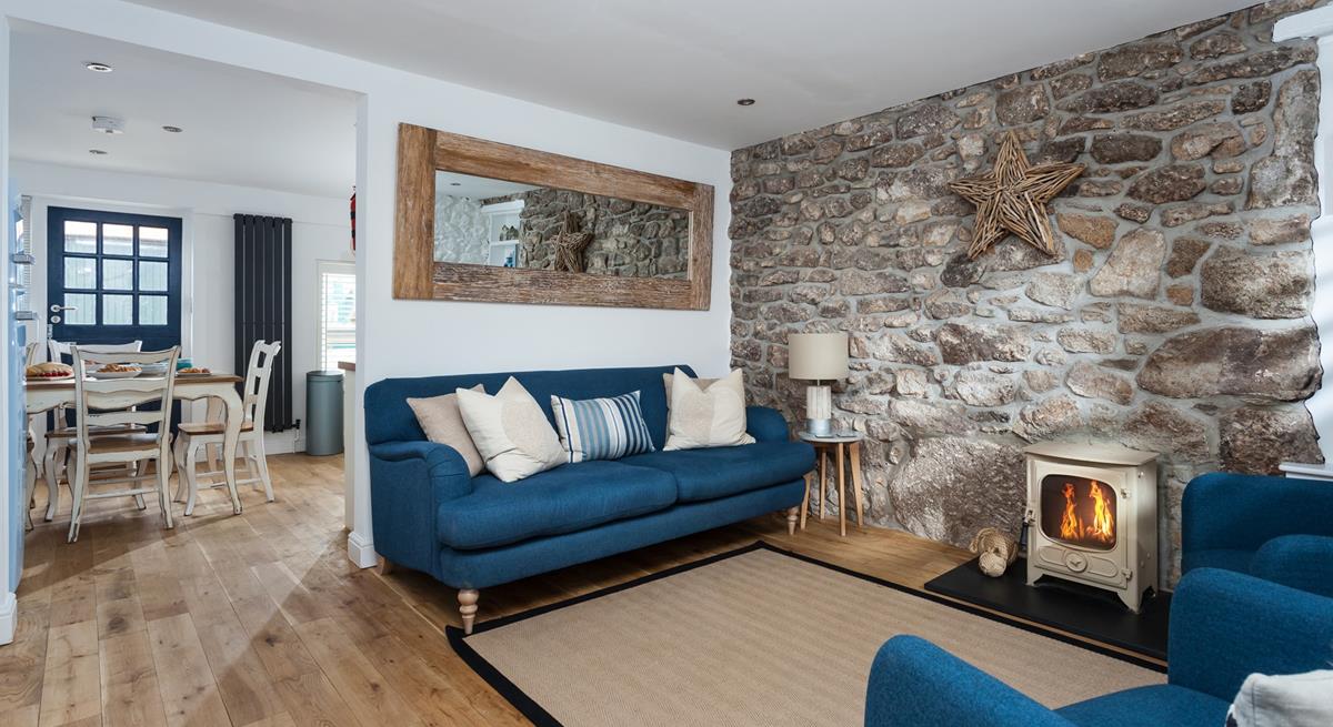 The contemporary sitting room features an occasional table with a wood and metal side lamp that provides soft lighting.