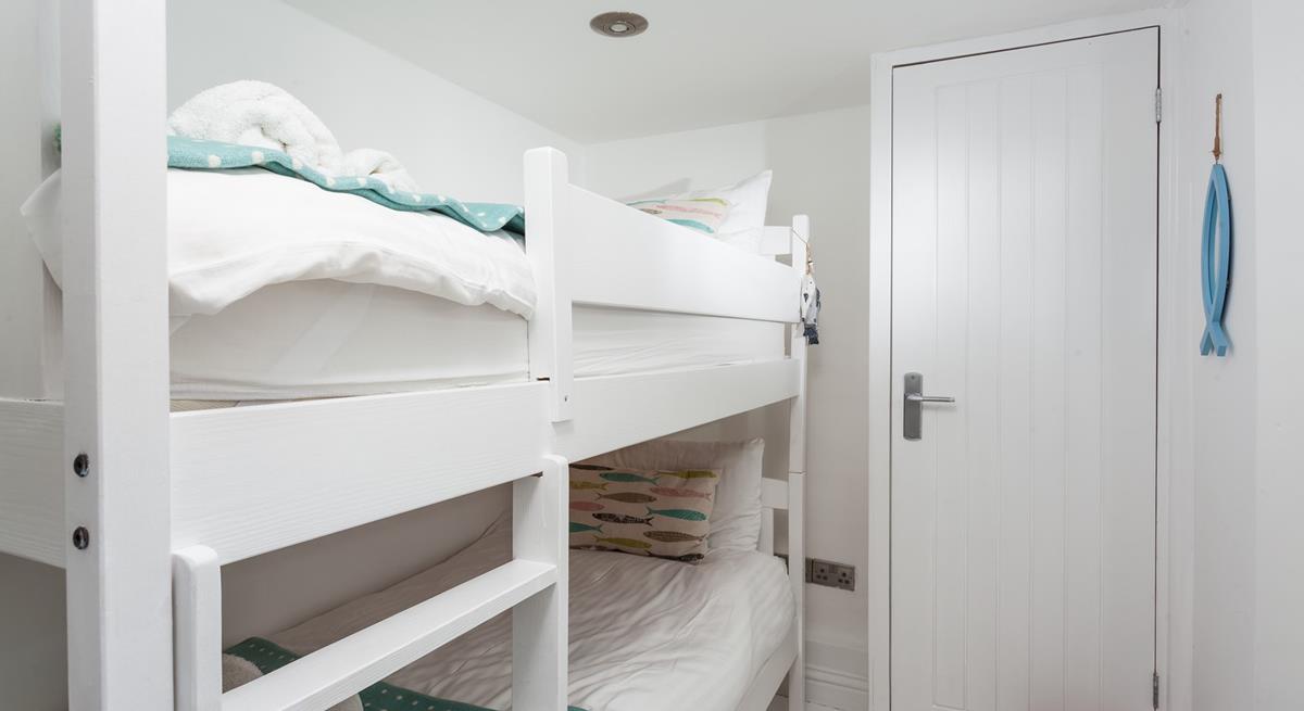 Bedroom 2 has painted wood bunk beds perfect for the little ones.