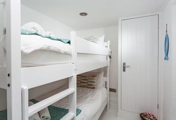 Bedroom 2 has painted wood bunk beds perfect for the little ones.